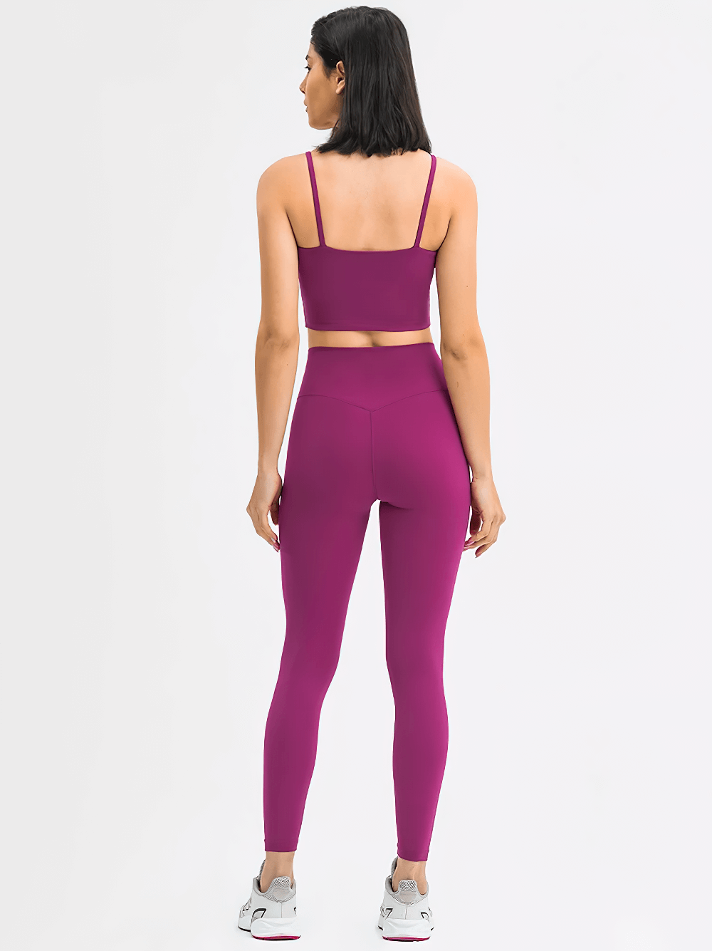 Back view of woman wearing Quick Dry Solid Color Sleeveless Yoga Set SF2144 in vibrant purple, showcasing eco-friendly, anti-pilling outfit.